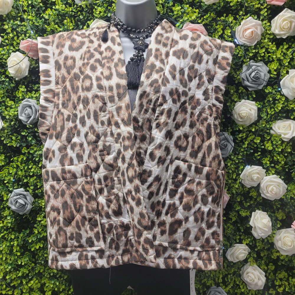 Leopard Print vest gilet on a mannequin with a greenery backdrop.