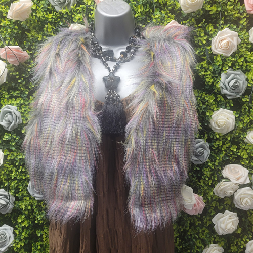 Multicolored fur gilet garment on a mannequin against a floral background