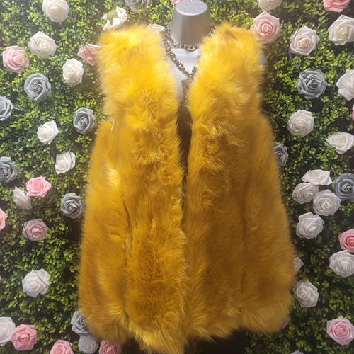 Yellow fur vest on a mannequin against a floral background