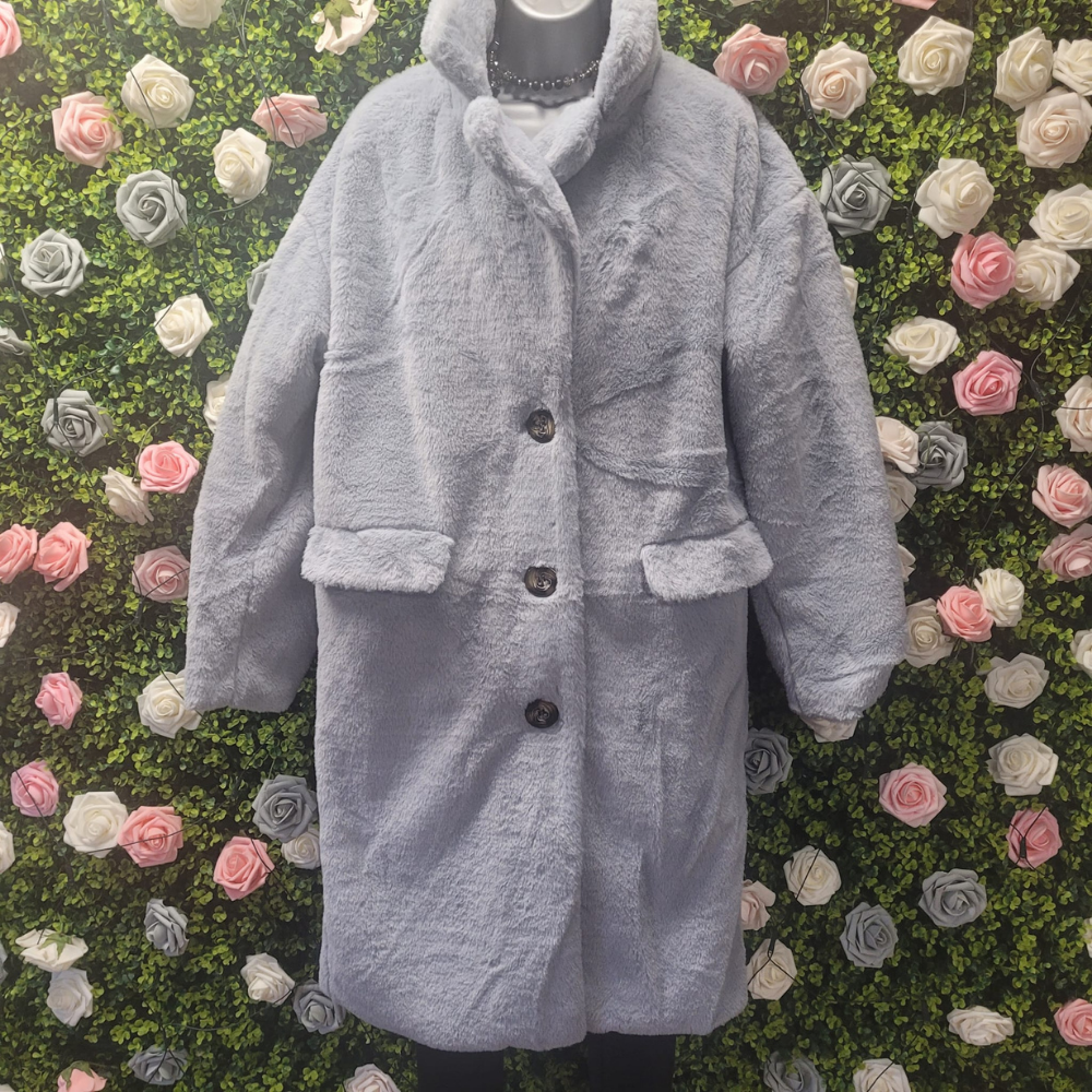 Gray coat on a mannequin against a floral wall