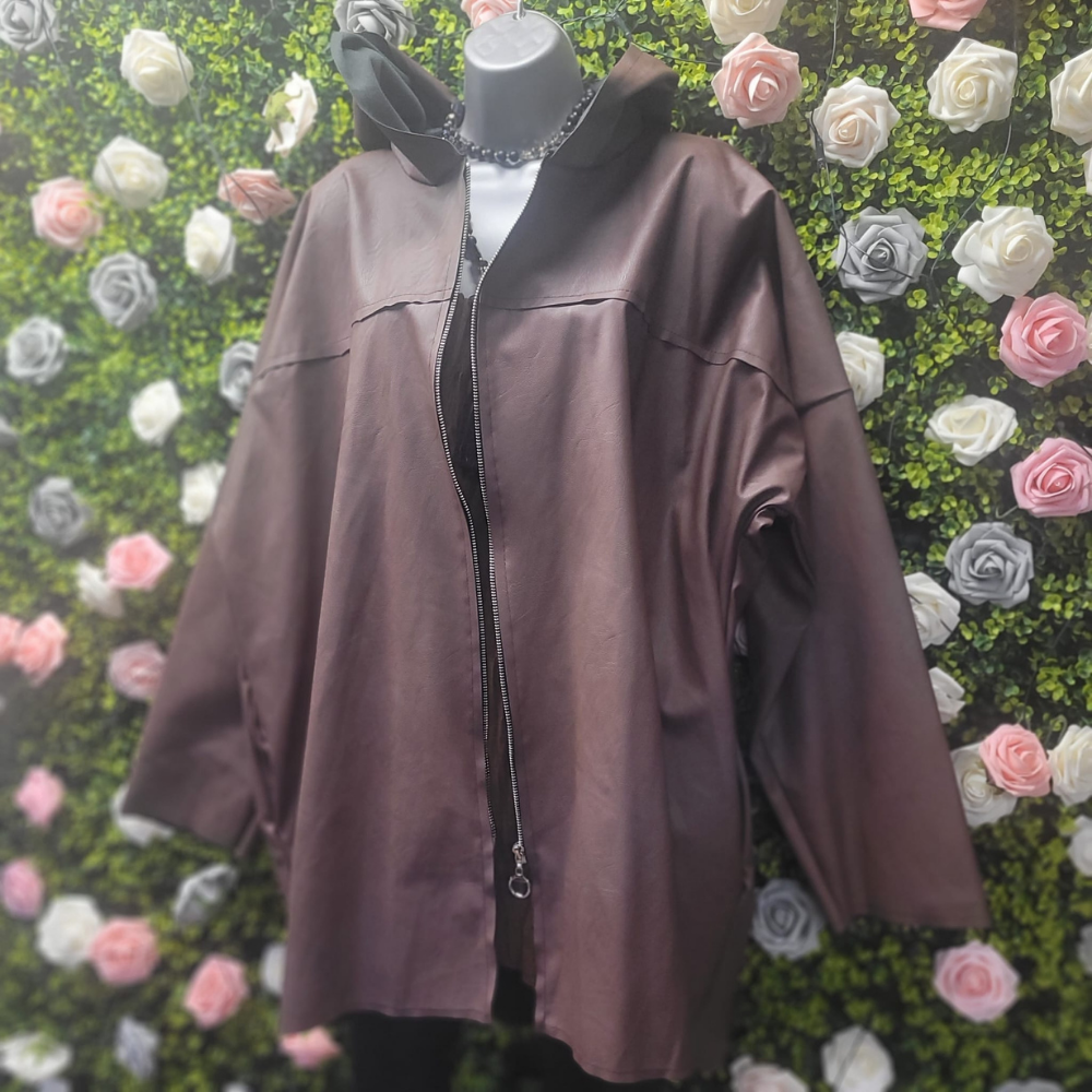 Brown leather jacket on a mannequin against a floral wall.