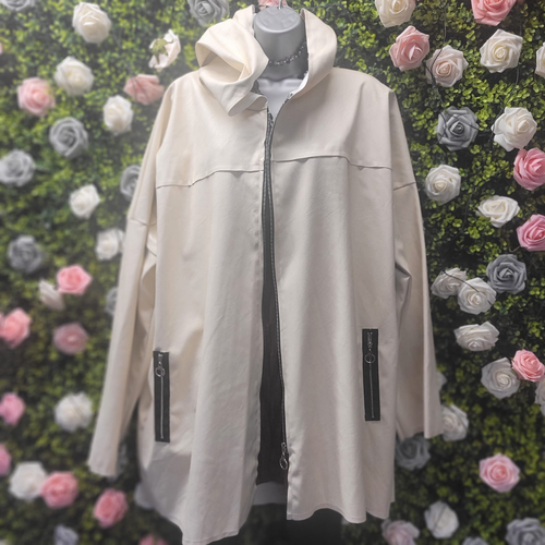 Beige jacket on a mannequin against a floral wall