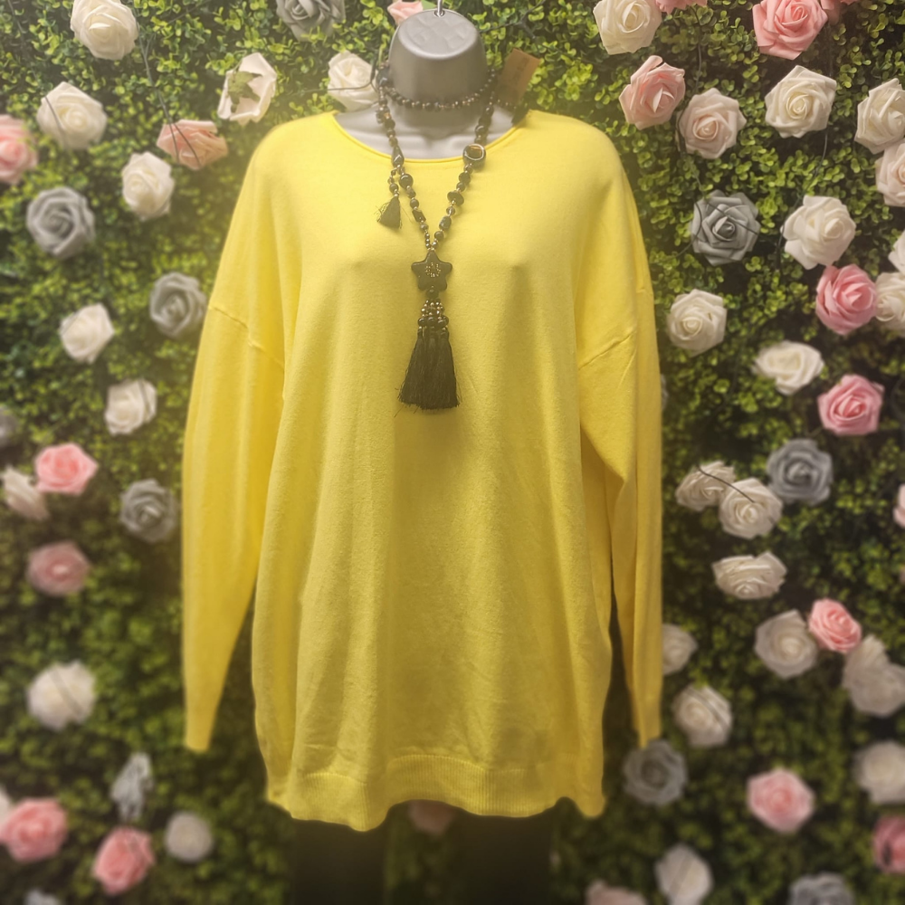Yellow jumper on a mannequin with a floral background