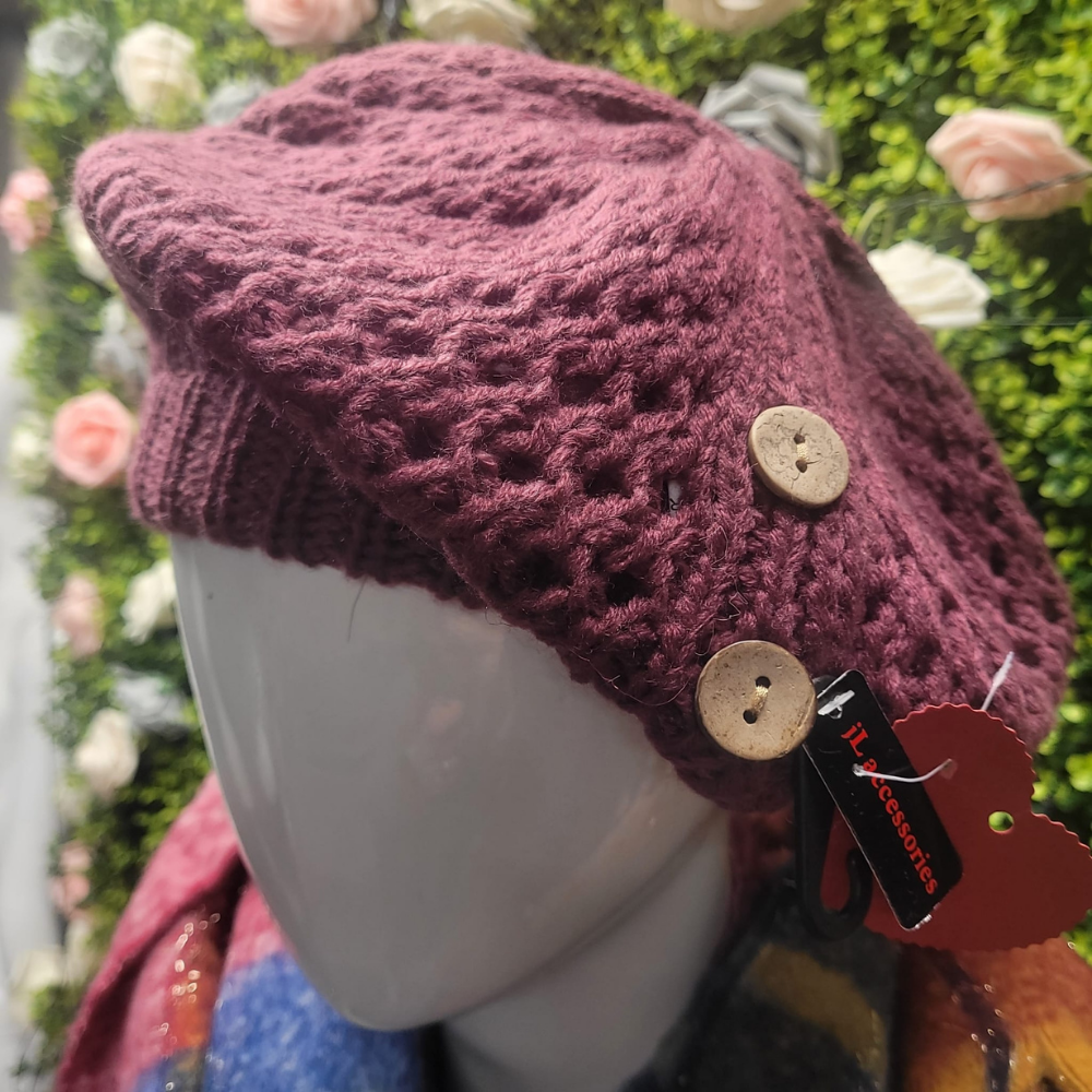 Knitted hat with button details on a mannequin head against a floral background