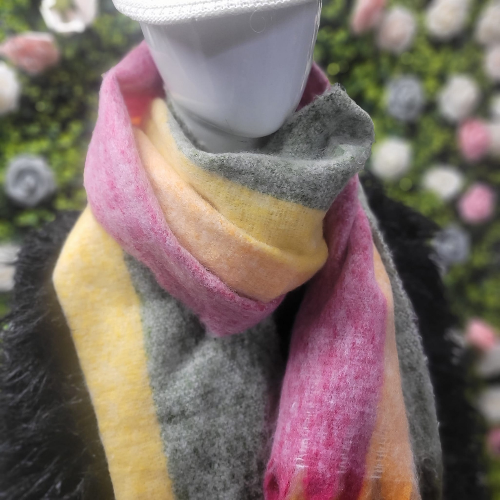 Mannequin wearing a colorful scarf with a blurred floral background