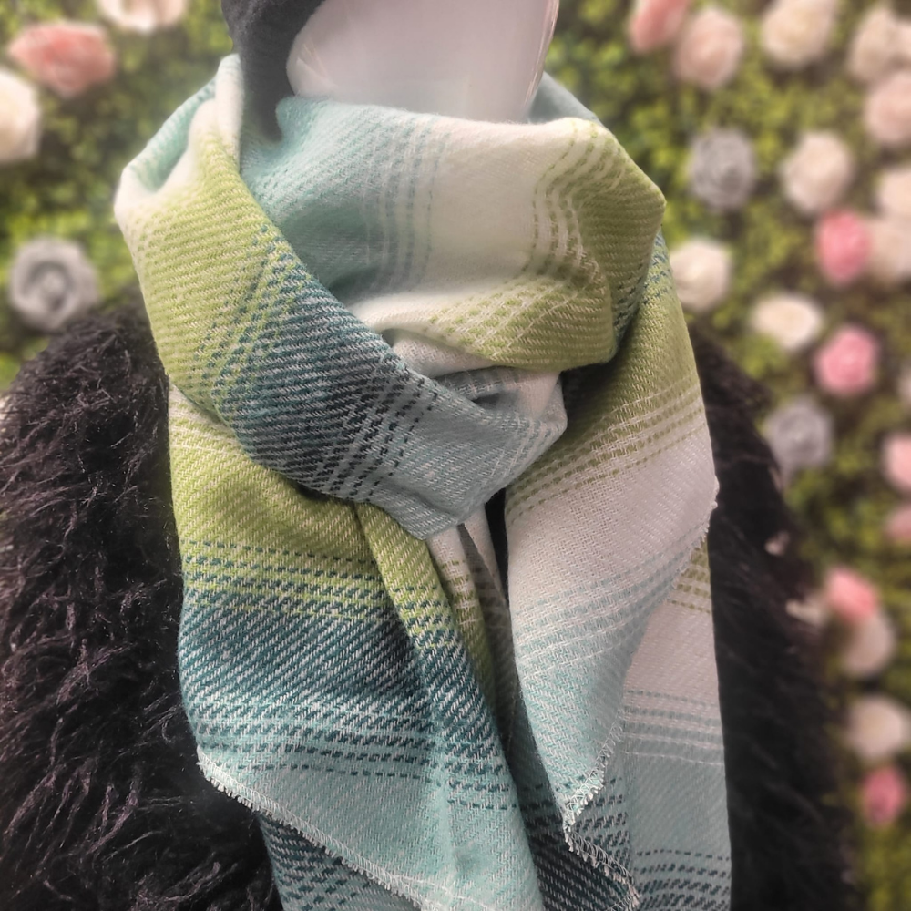 Multicolored plaid scarf on a mannequin with a floral background