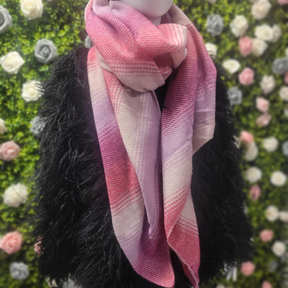 Pink and purple scarf draped over a black furry garment with a floral background