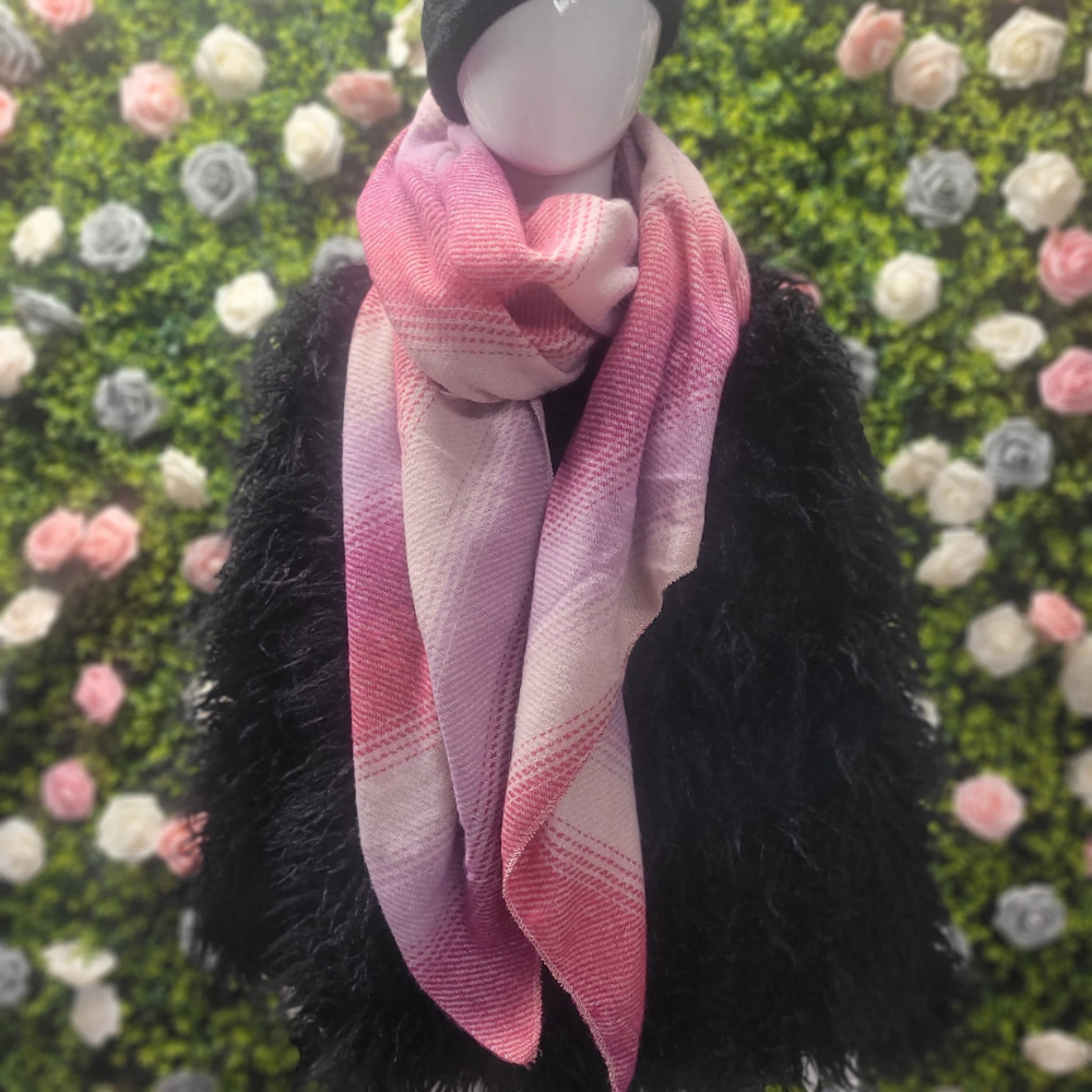 Mannequin wearing a pink scarf with a floral background
