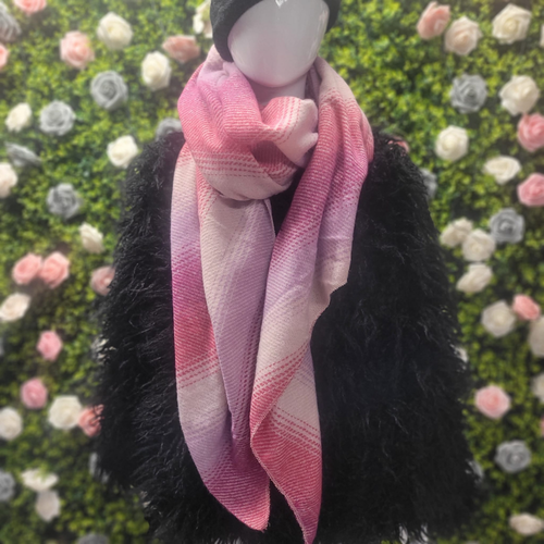 Mannequin wearing a pink scarf with a floral background