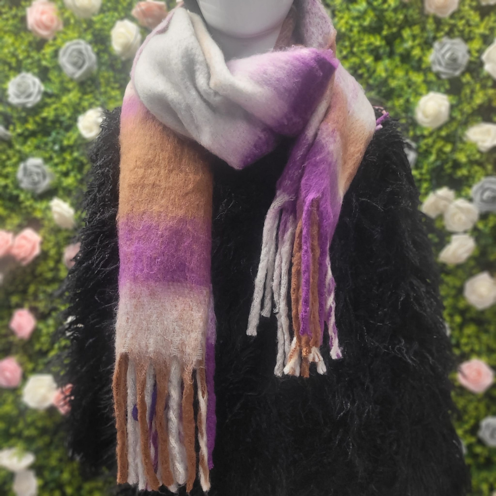 Multicolored scarf with fringes on a mannequin against a floral background