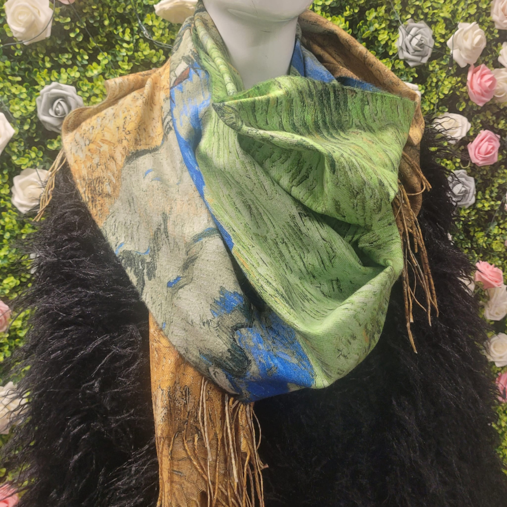 Mannequin wearing a green scarf with floral patterns against a decorative background with flowers.