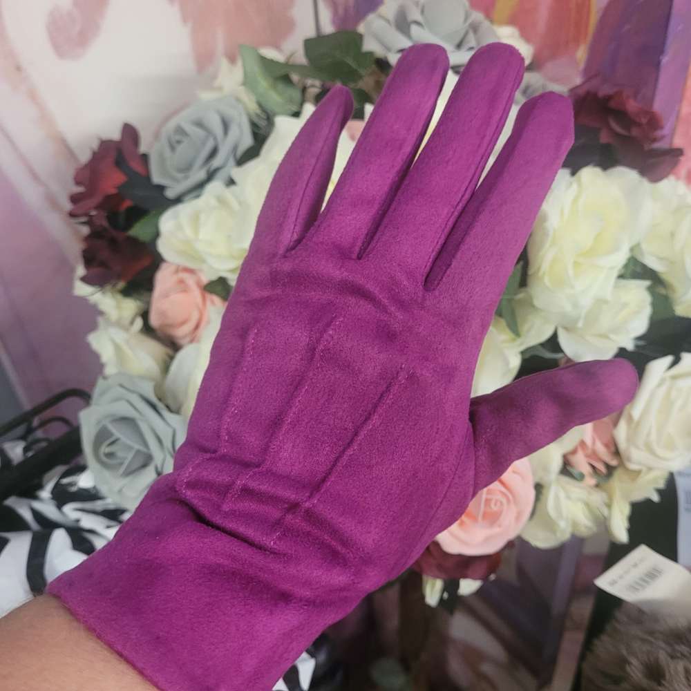 Purple glove held in front of a floral arrangement