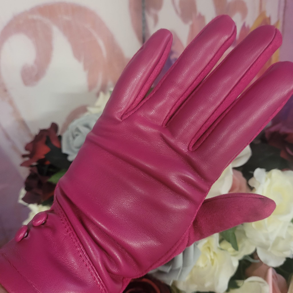 Pink leather glove held against a floral background