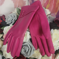 Pink gloves on a bed of flowers with a colorful background