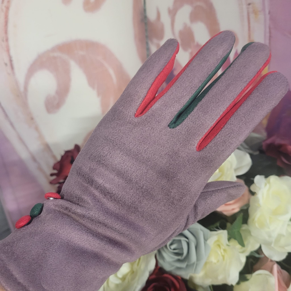 Lilac glove with red and green accents worn by a person against a floral background
