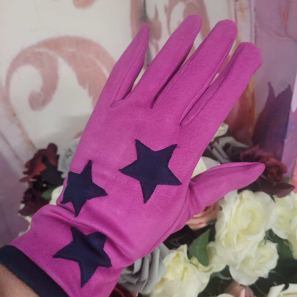 Pink glove with star patterns held against a floral background