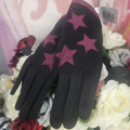 Black gloves with pink stars on a floral background
