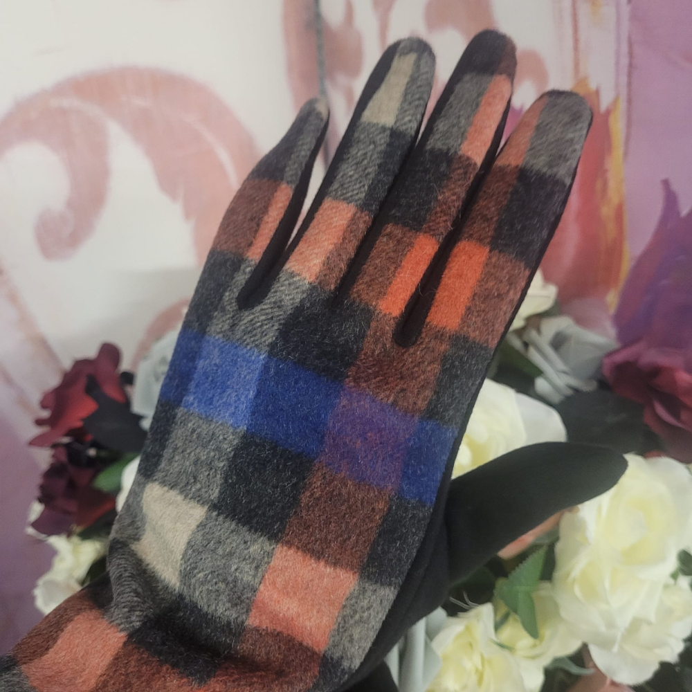 Plaid patterned glove on a hand with a floral background