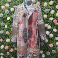 Rose coloured jacket with animal print on a greenery backdrop