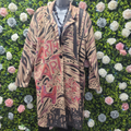 Longline, animal print, mutlicoloured jacket on a mannequin in front of a greenery wall.