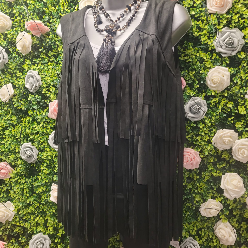 Black tasseled Gilet on a greenery wall backdrop