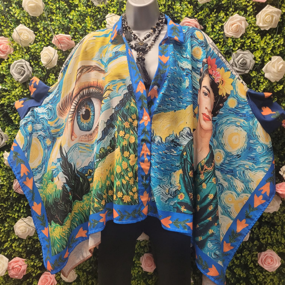 Asymmetrical Blouse with vibrant Frida print in blue hues on a greenery backdrop