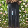Black wide leg coords on a mannequin with a greenery backdrop