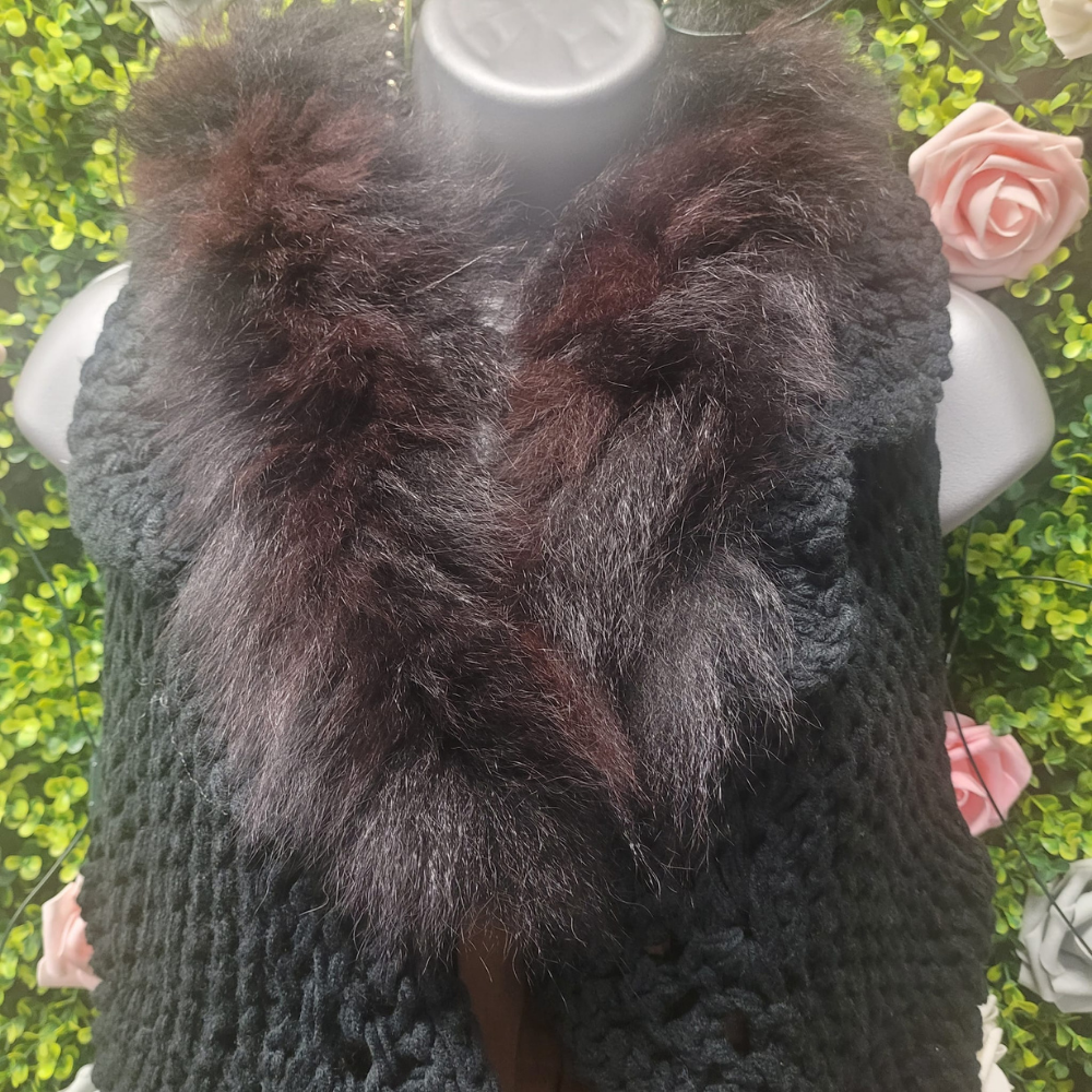 Faux fur collared wool blend gilet in black on a mannequin with a greenery backdrop